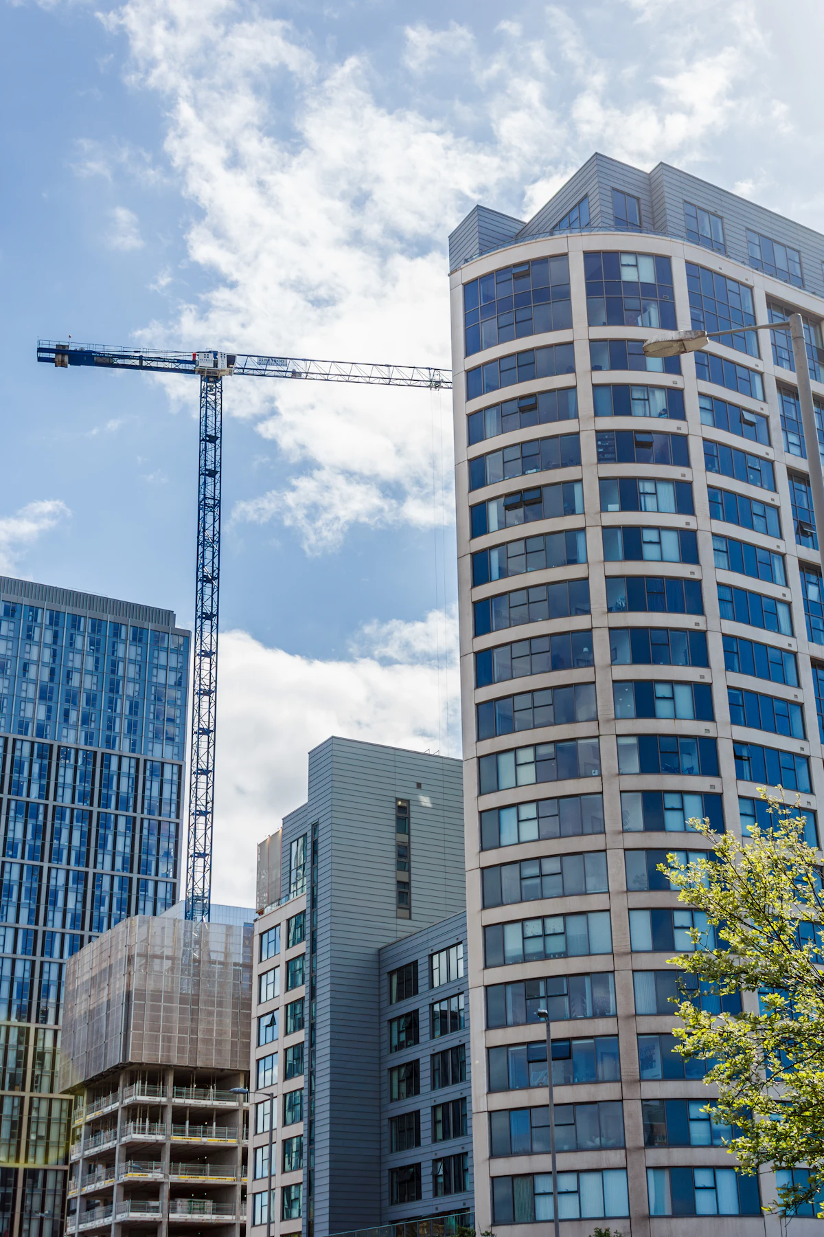 Construction crane and building illustrate coordinated sourcing and delivery