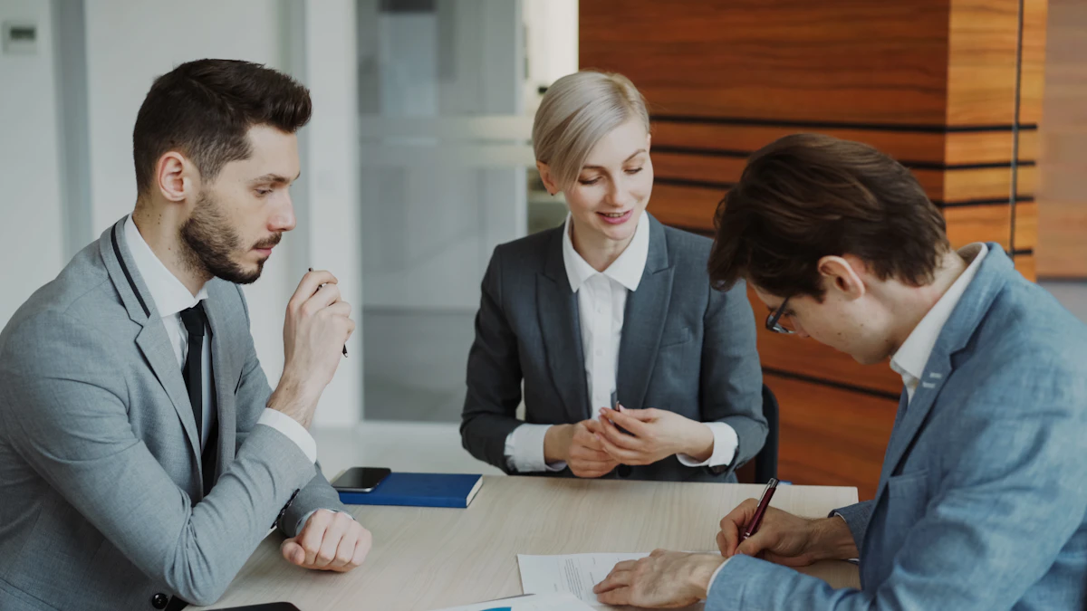 Business colleagues reviewing and signing documents at a table