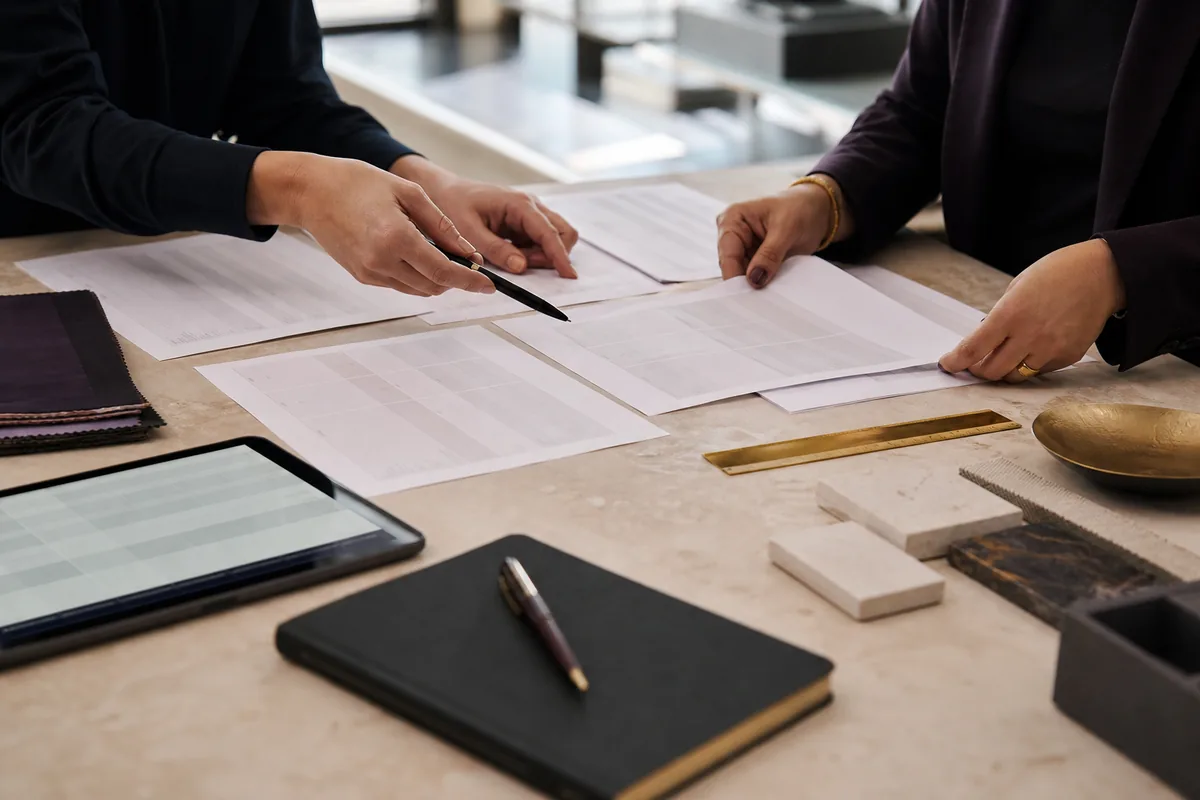 Professionals comparing vendor proposals and material samples
